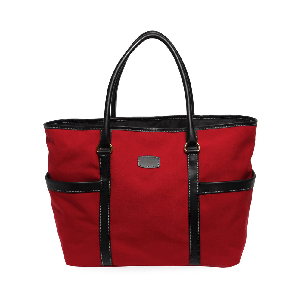 Front view of Town and Country Tote showcasing red canvas body with black leather trim, two exterior side pockets, and double top handles on white background