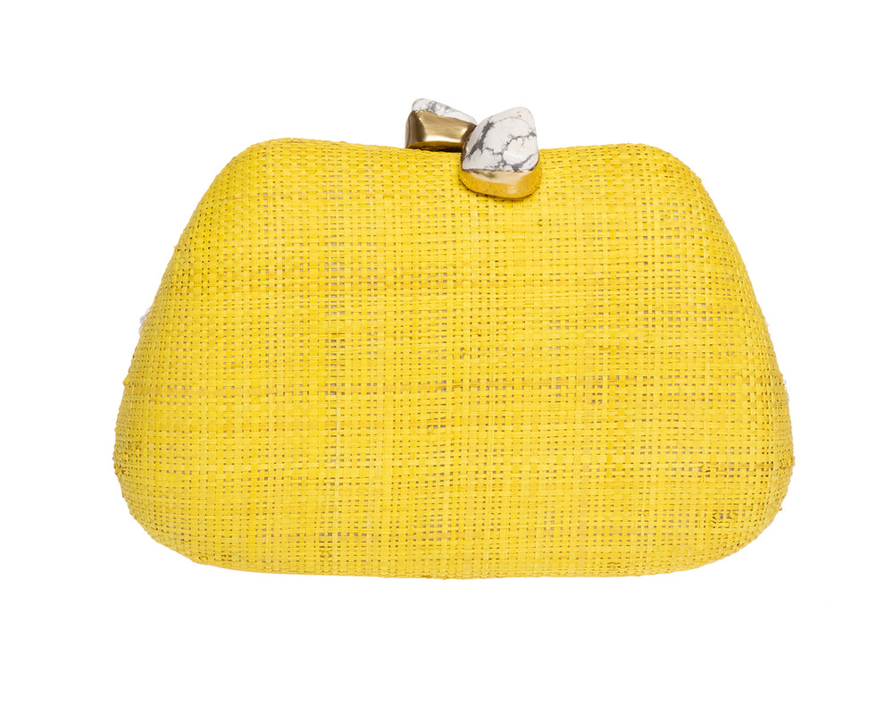 Front view of Tamu top-handle clutch showcasing yellow raffia texture and marbled stone kiss-lock clasp on white background