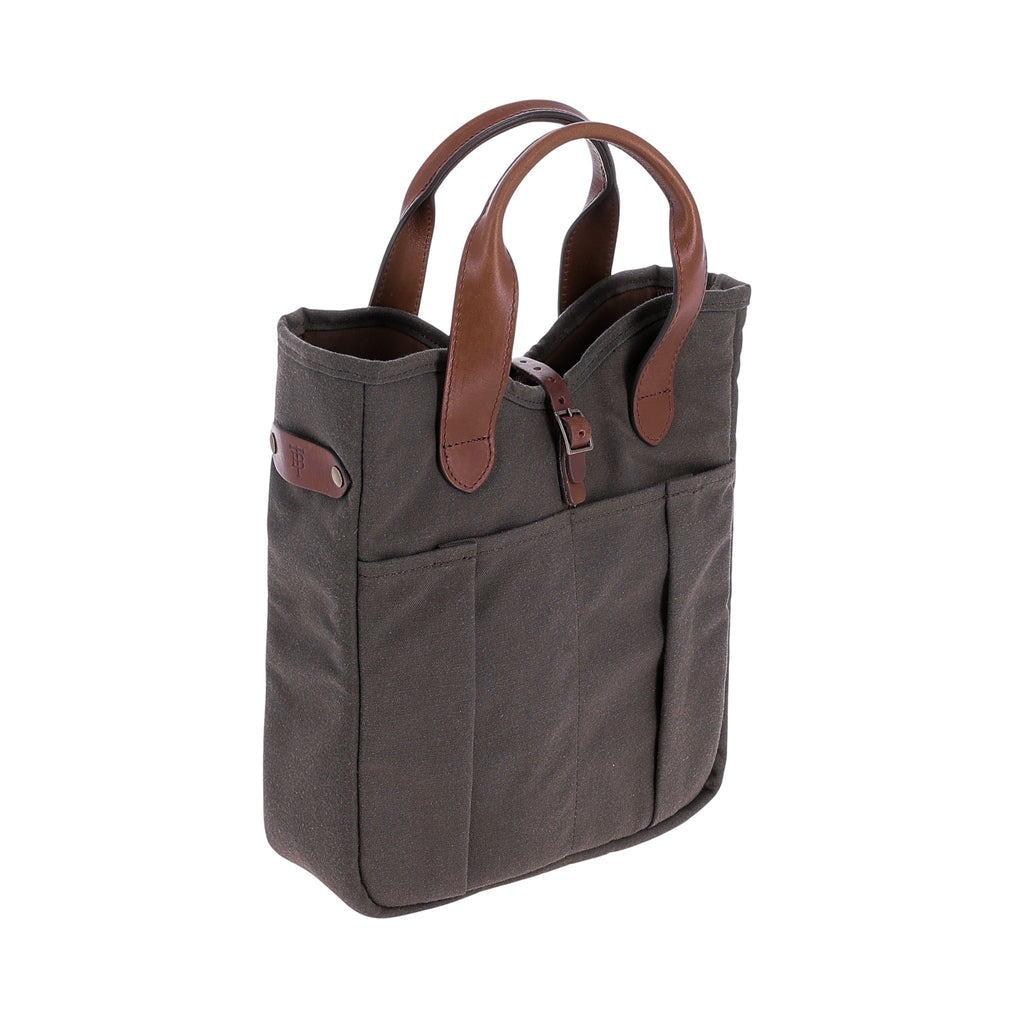 Three-quarter view of Bark Canvas Whiskey Tote showcasing leather handles and exterior pockets with white background