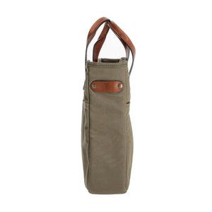 Side view of Canvas Whiskey Tote showcasing leather carry handles and exterior slip pockets with a white background