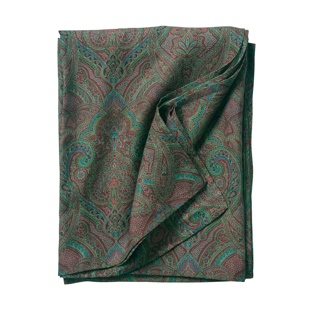 Folded view of Juliska Paisley tablecloth in Evergreen showcasing green and blue paisley print on white background