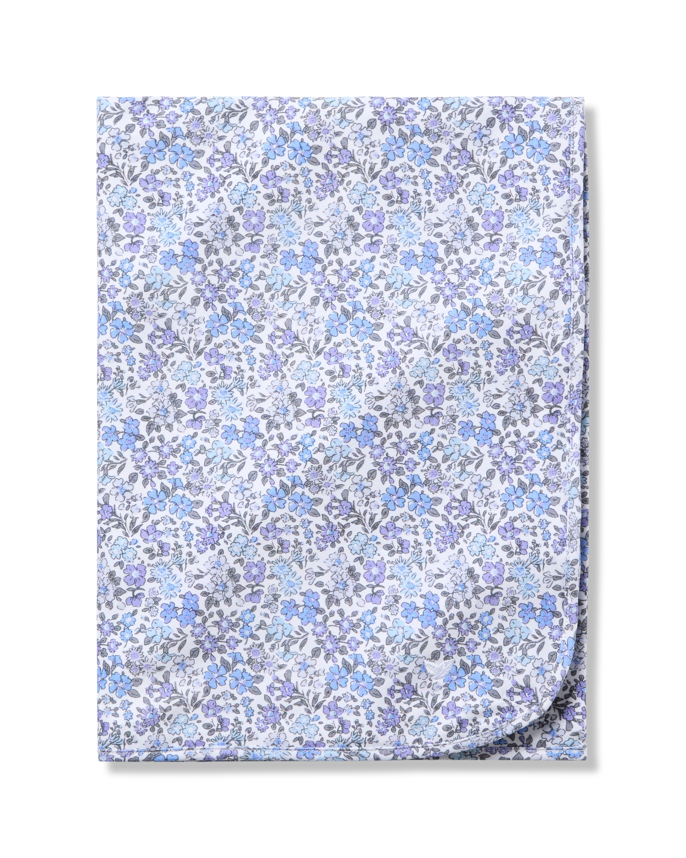 The Petite Plume Pima Baby Blanket in Fleur dAzur is crafted from soft Pima Cotton and showcases a vintage-inspired print of tiny blue and purple flowers on a white background.