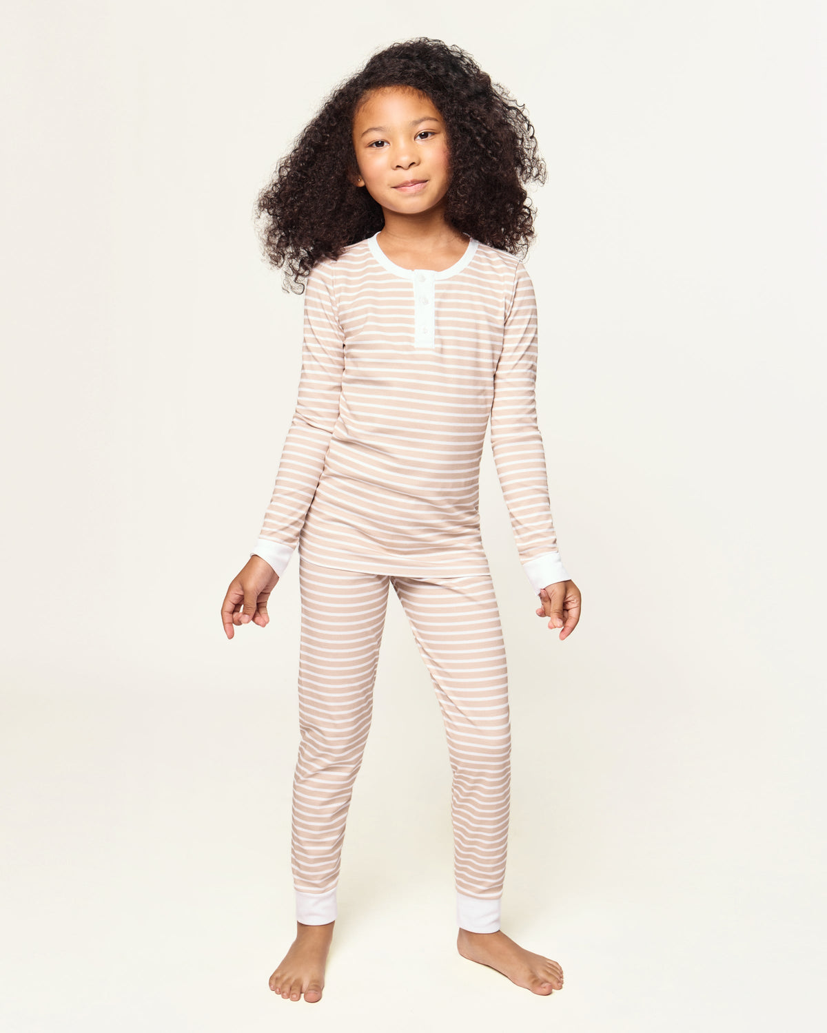 Front view of Kid’s Pima Snug Fit Pajama Set in Camel Stripe showing snug fit on a child against a light background