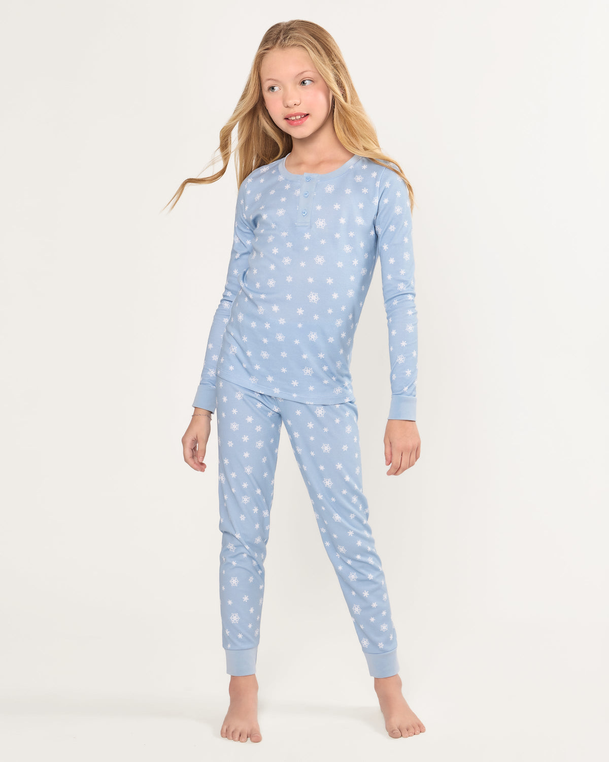 Front view of Kid’s Pima Snug Fit Pajama Set in Periwinkle Wonderland with white snowflake print on a plain background