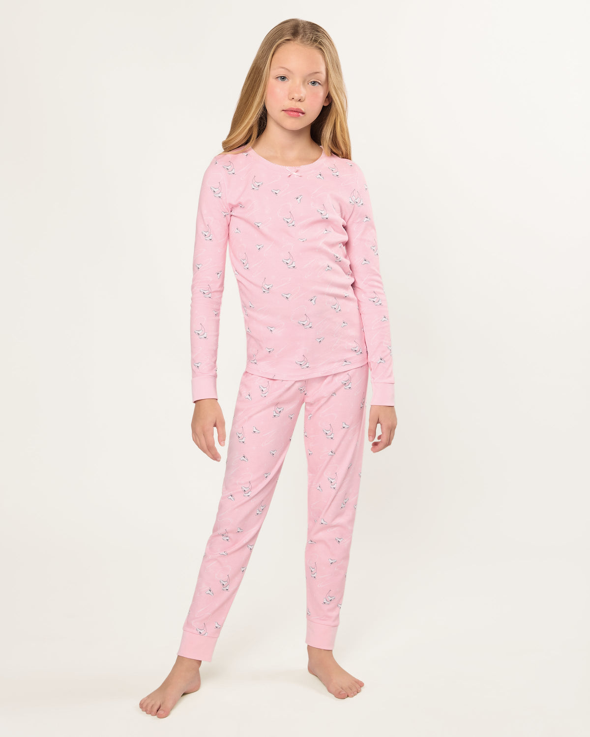 Front view of Kid’s Pima Snug Fit Pajama in Winter Skates showing pink skate print on model against white background