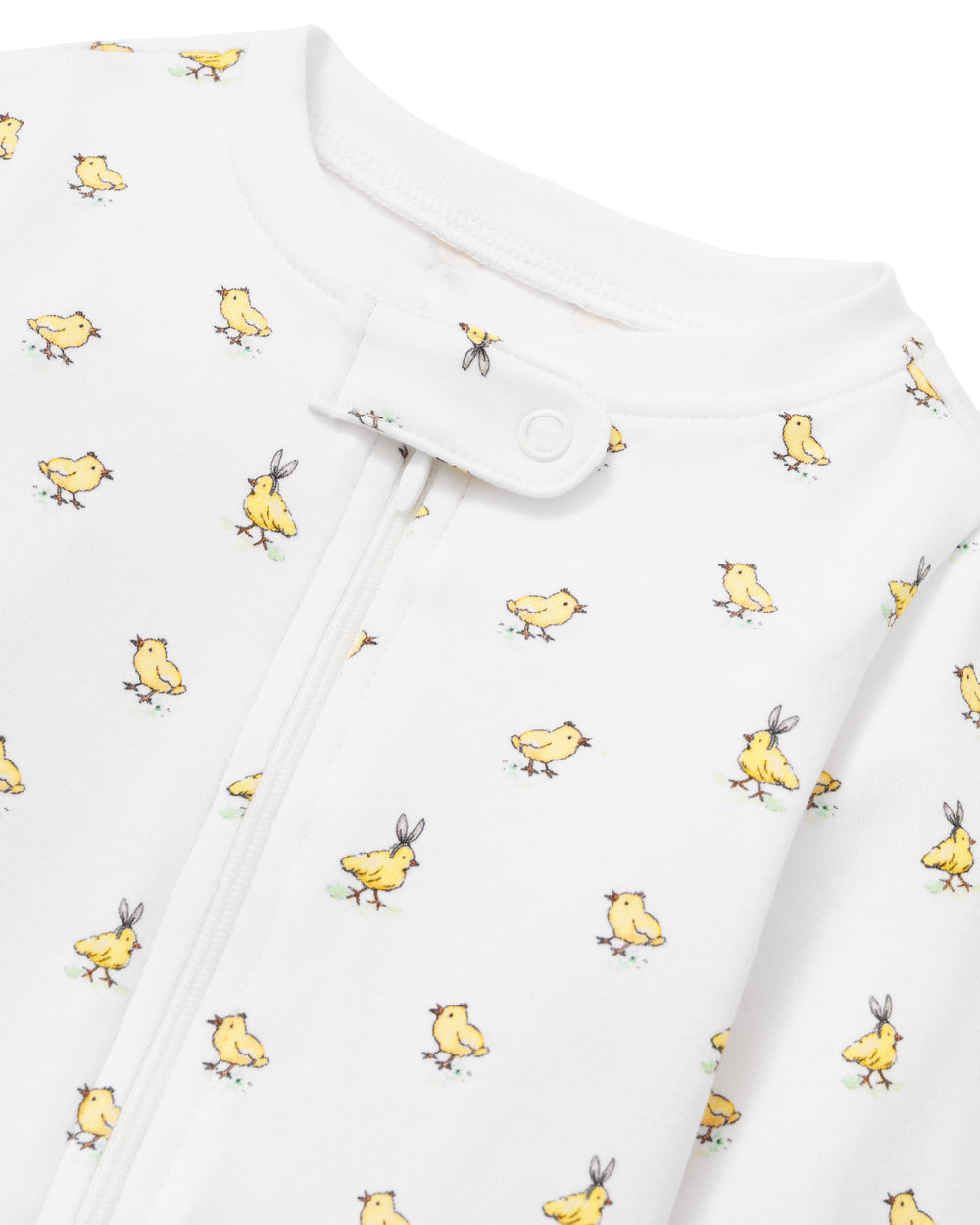 Close-up of Baby’s Pima Romper in Très Chick showing yellow chick print and front zipper on white background