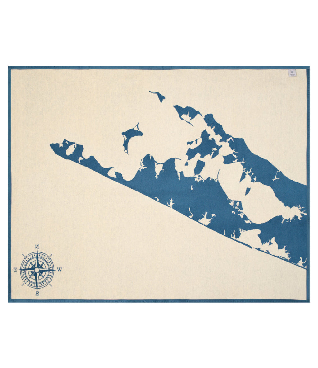 Cream blanket with dark blue map of the Hamptons region and compass rose in lower left corner.