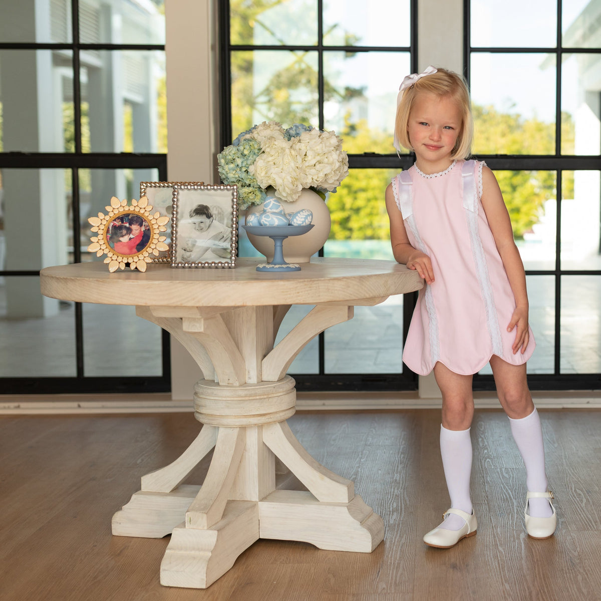 Girl wearing the Henry Duvall Rosie Dress, a classic pink girls dress designed for spring celebrations and family portraits.