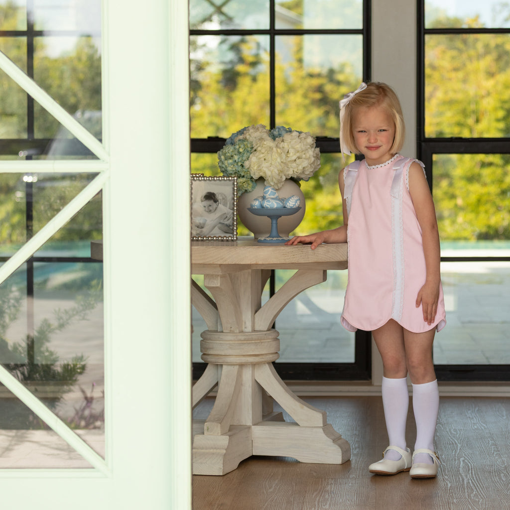 Girl wearing the Henry Duvall Rosie Dress, a classic pink girls dress designed for spring celebrations and family portraits.