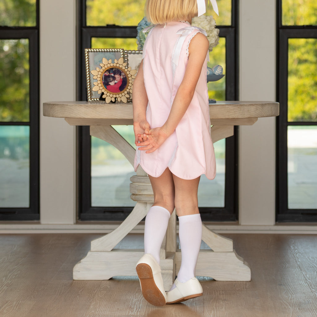 Girl wearing the Henry Duvall Rosie Dress, a classic pink girls dress designed for spring celebrations and family portraits.