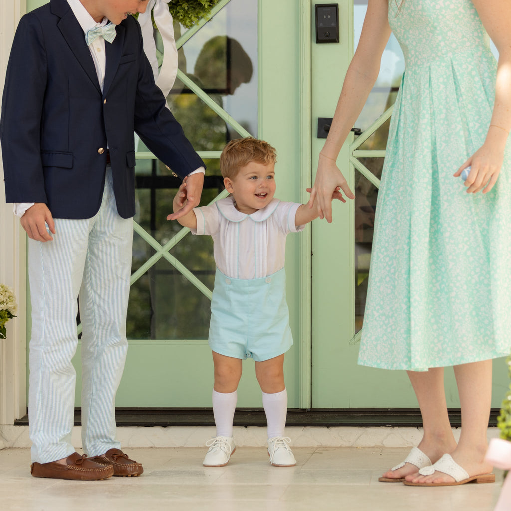 Boy wearing the Henry Duvall Bradford Trousers, a polished boys trouser styled for spring occasions and sibling coordination.