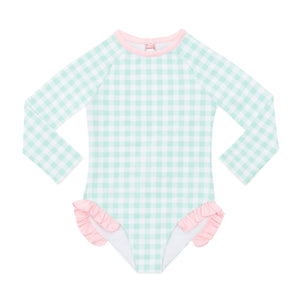 Girls’ long sleeve rashguard one piece swimsuit in Seaside Seersucker with UPF 50+ and scalloped open back, perfect for summer or beach vacations by Henry Duvall.