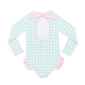 Girls’ long sleeve rashguard one piece swimsuit in Seaside Seersucker with UPF 50+ and scalloped open back, perfect for summer or beach vacations by Henry Duvall.