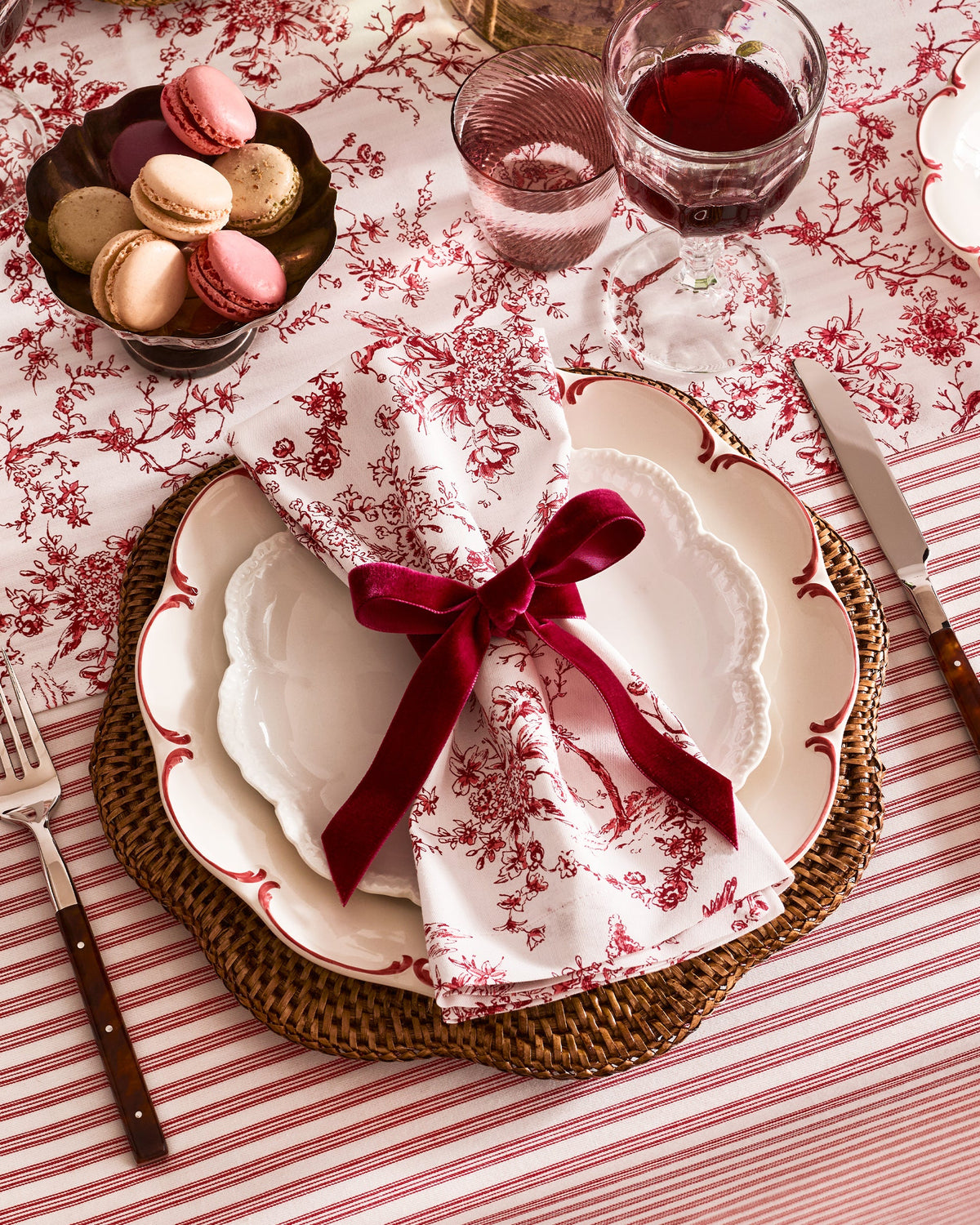 Angled view of Signature Twill Napkins in Red Timeless Toile, Set of 4 showcasing red floral print with a festive table setting
