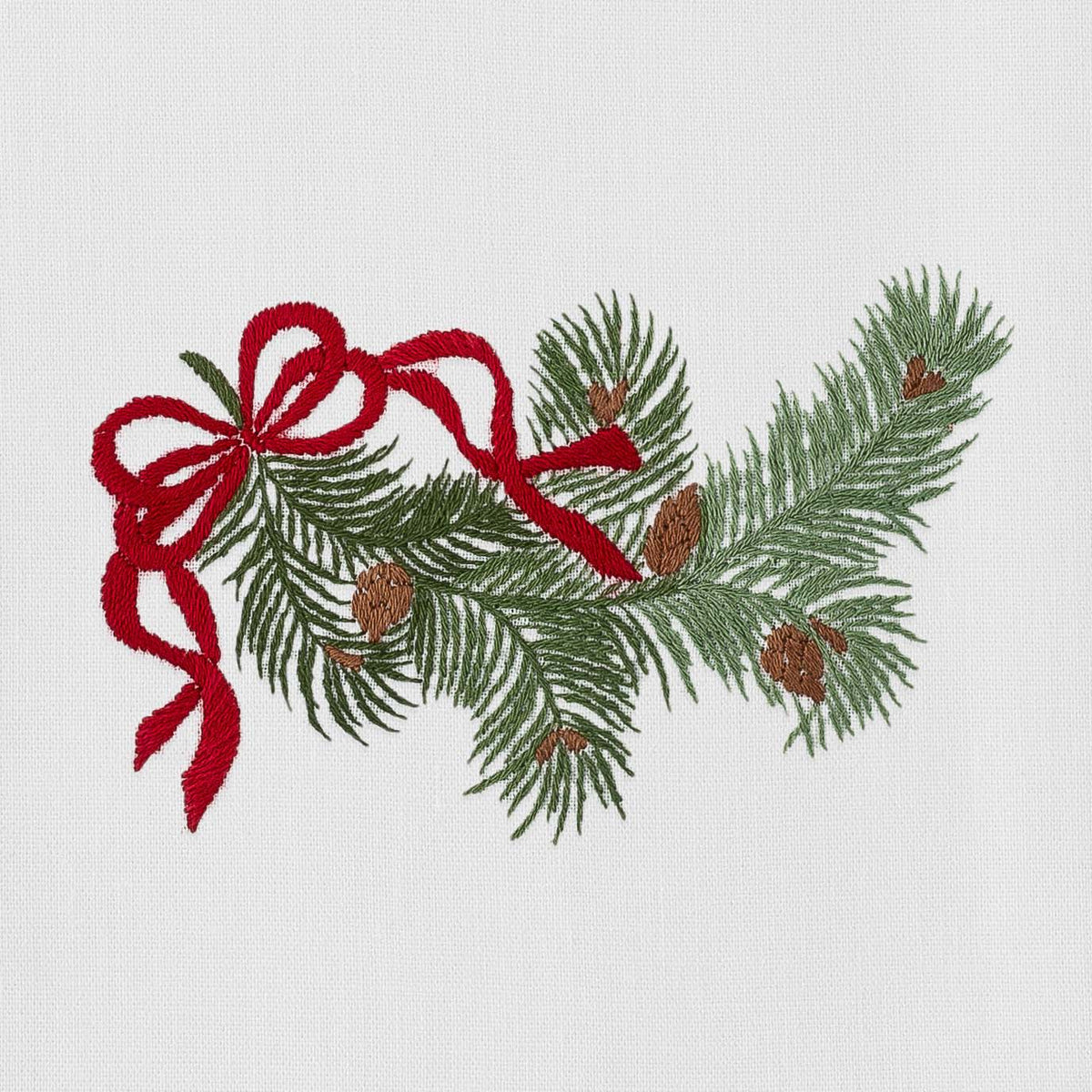 Close-up of Pine Bough Ribbon Napkin showcasing embroidered pine boughs and red ribbon on white cotton fabric