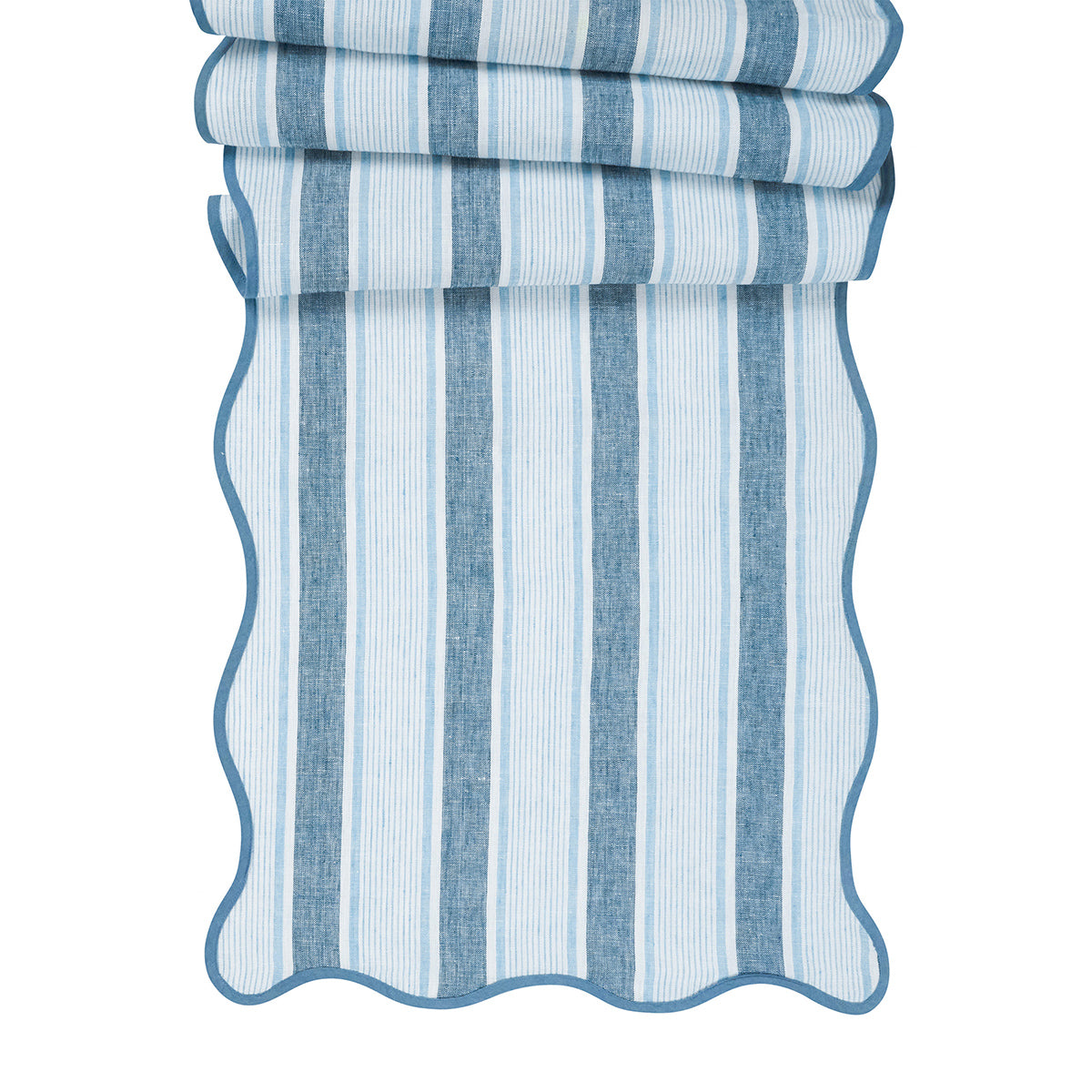 Front view of Cabana Stripe table runner in Ocean showcasing blue vertical stripes and scalloped trim on white background
