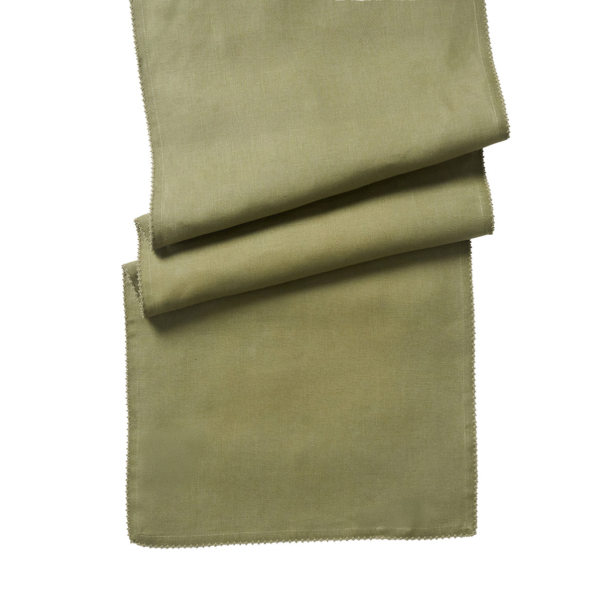 Angled view of the Berry Scallop 18 by 90 inch table runner in sage showcasing its scalloped trim on a white background