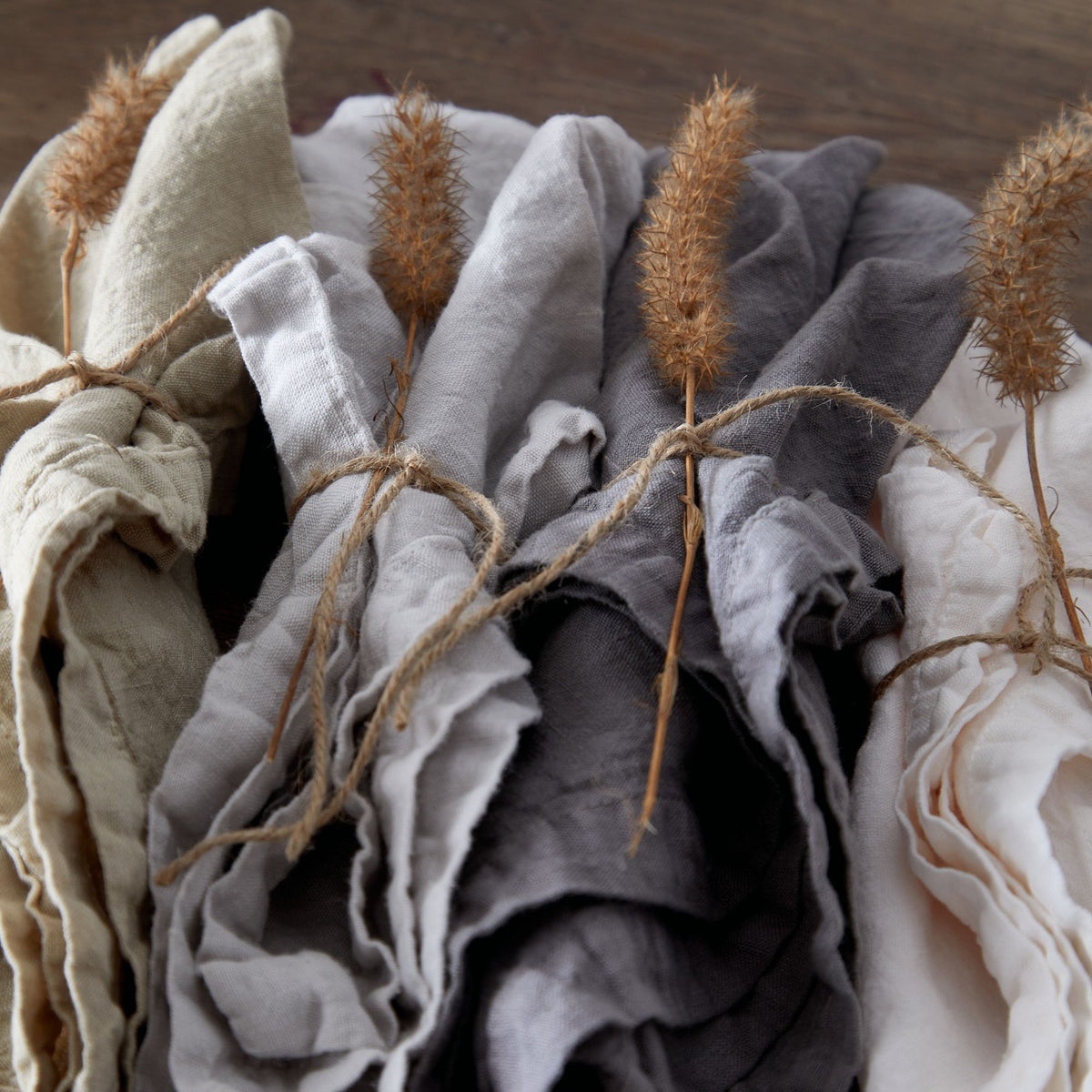Close-up of Maria Collection Napkins in Chalk White showcasing washed linen texture with dried botanicals and twine
