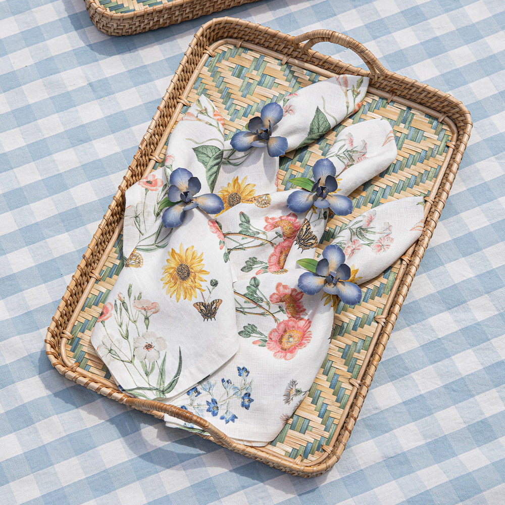Angled view of Villa Seville 18-inch tray showcasing handwoven chambray pattern and integrated handles on blue gingham cloth