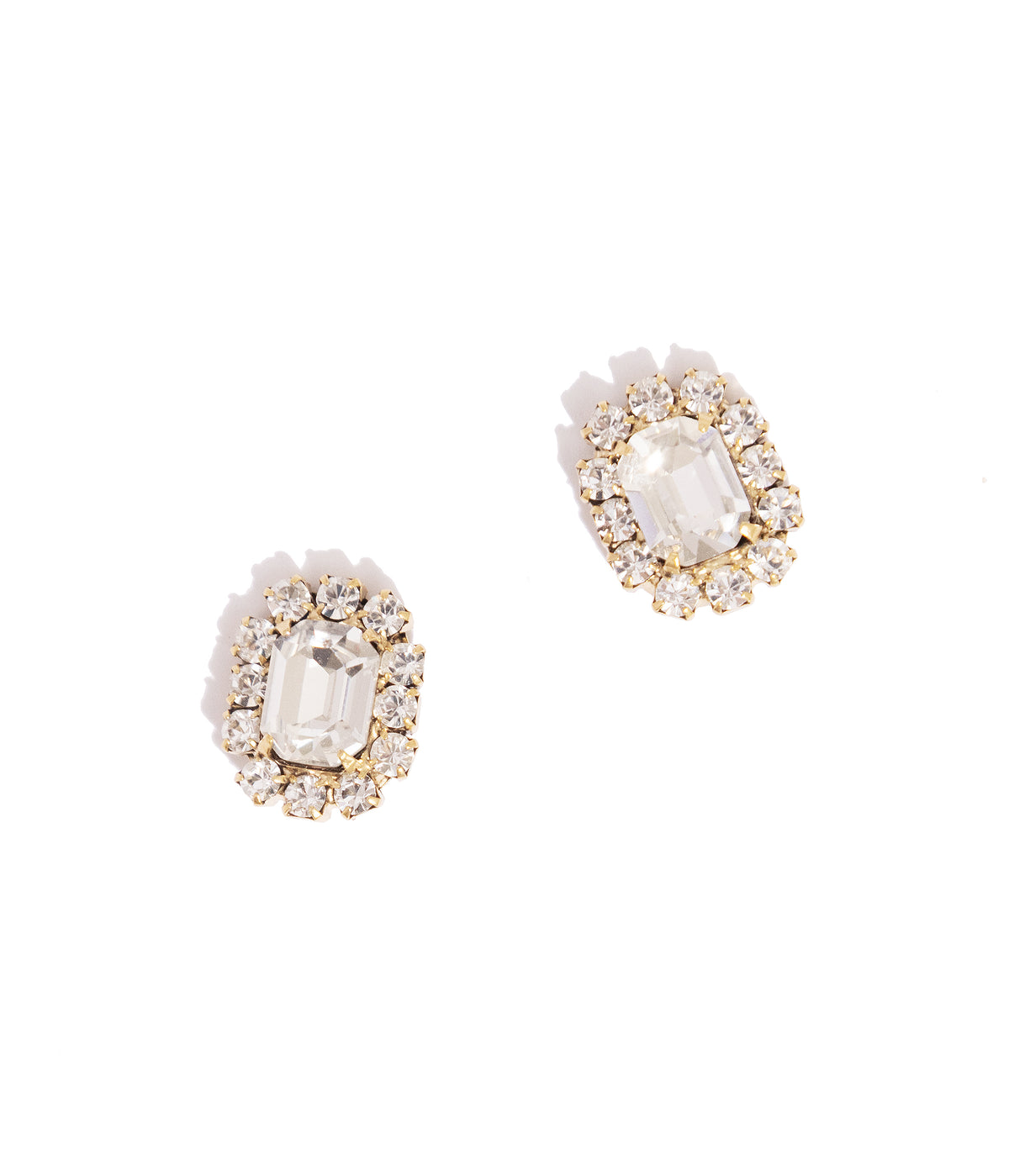 Close-up view of Tati Studs in Crystal showcasing hand-set crystals and 18K antiqued gold finish on white background