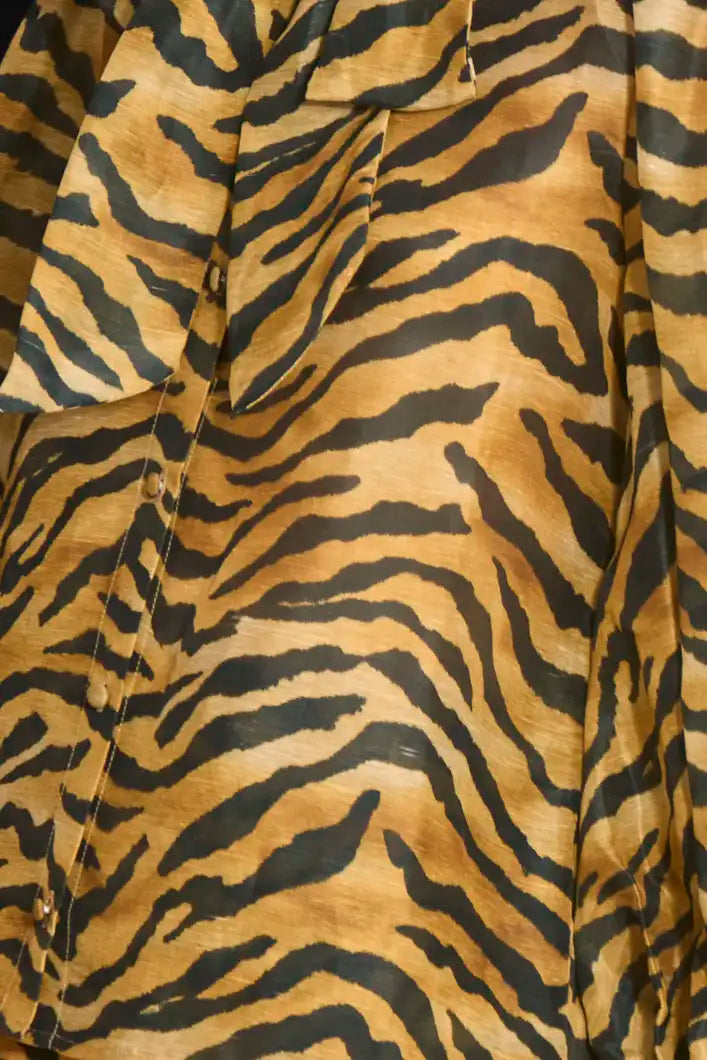 The Tess Blouse in Tiger print, has an elegant tie-front neckline that can be styled into a bow.
