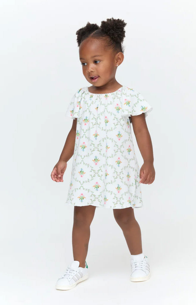 Front view of Baby Keira Dress in Pastel Trellis print showing smocked bodice, ruffle straps, and full skirt on a toddler against a white background