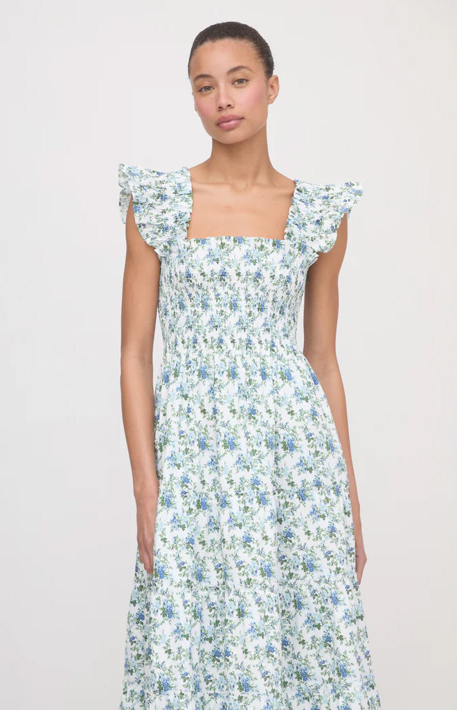 Front view of The Ellie Nap Dress in English Daisy showcasing ruffled shoulders and tiered midi skirt on white background