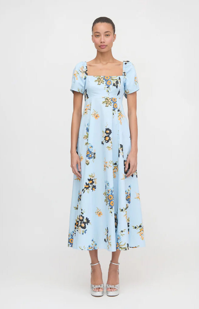 Front view of The Matilda Dress in Sloane Floral (light blue) showing fitted empire waist, puff sleeves, and midi full skirt