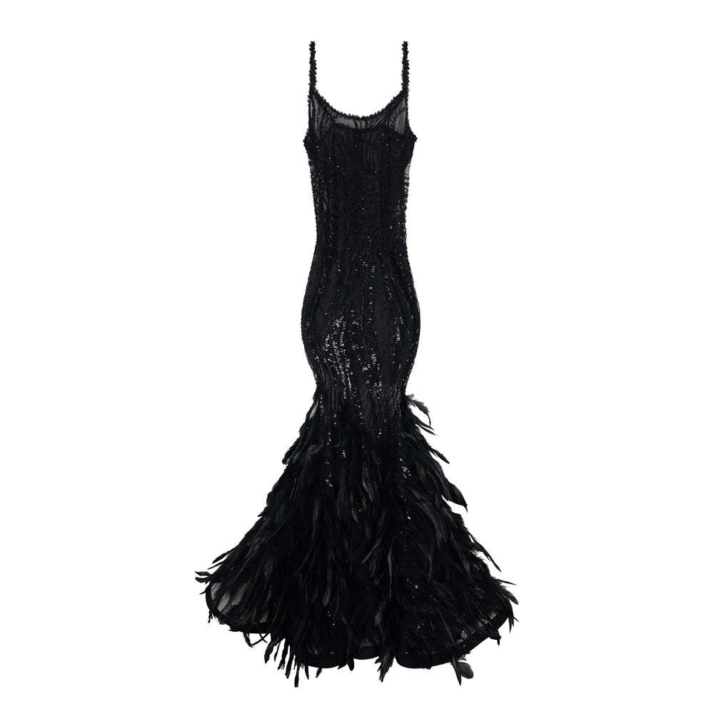 Front view of Phoenix Feather Dress, fitted black mermaid gown with sequin beading, sheer straps and feather hem on white