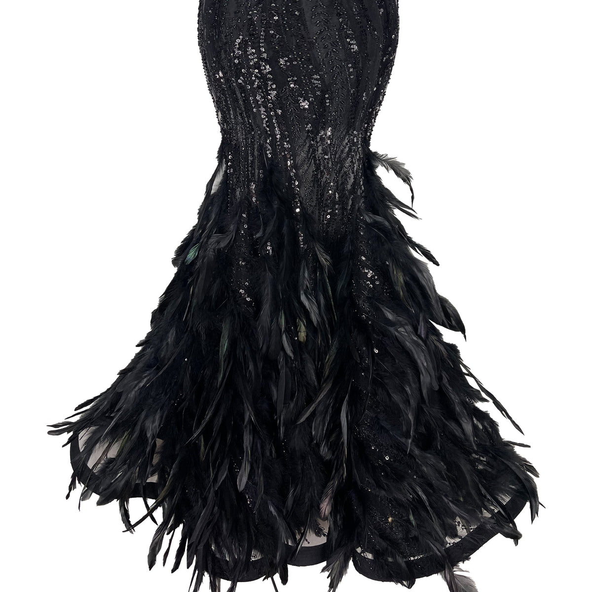 Close-up of The Phoenix Feather Dress showing mermaid hem with black feathers and sequin embellishments on white background