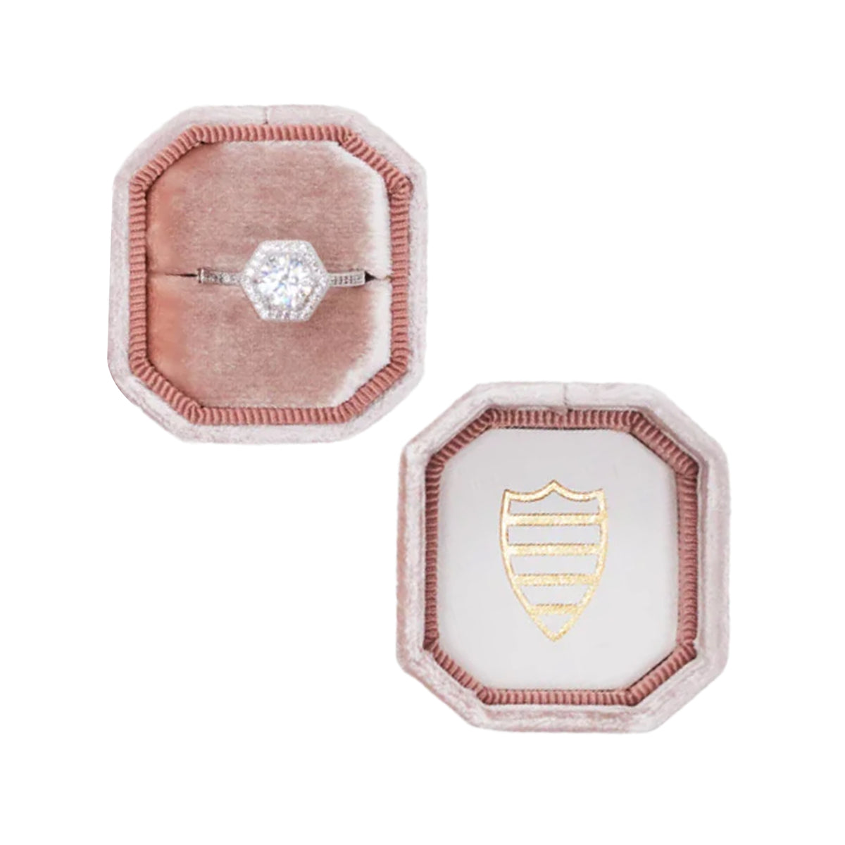 Top-down view of The Hope Bevel Single ring box showing blush-pink velvet octagonal box with a diamond ring in the base and gold shield on the lid, white background