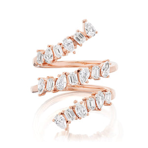 The Triple Wraparound Ring With Mixed Shape Diamonds features three overlapping 18k rose gold bands, each set with oval, marquise, and baguette cut diamonds arranged in an eye-catching alternating pattern.