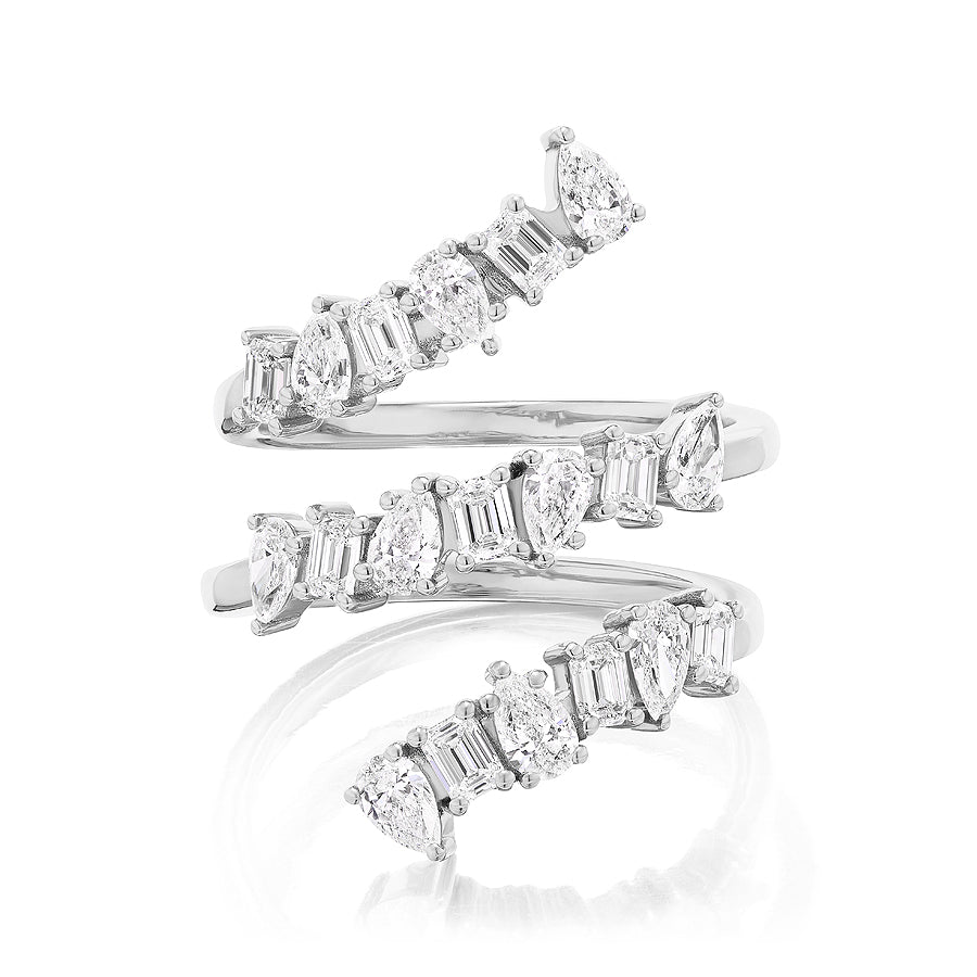 The Triple Wraparound Ring With Mixed Shape Diamonds showcases three overlapping silver bands, each set with baguette, round, oval, and pear diamonds in a scattered, elegant design.