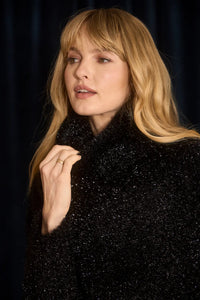 The turtleneck is made with shimmering yarn, oversized, long sleeves, and slightly cropped fit.