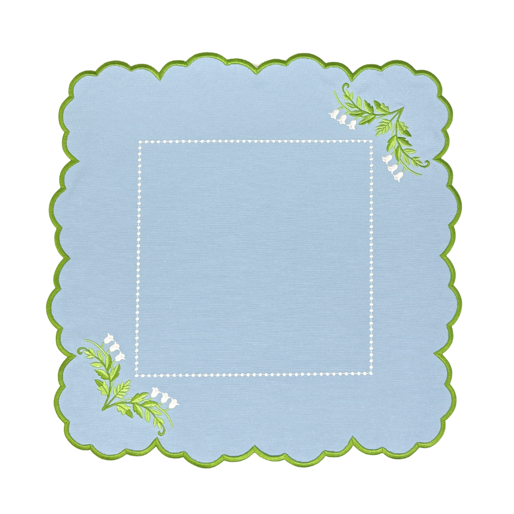 Decorative luxury blue placemat with green scalloped edge and lilly of the valley designs 
