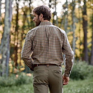 Man outdoors in woods, back to camera, wearing Tom Beckbe Dixon Brushed Cotton Twill Shirt and khaki pants.