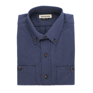 A folded Dixon Brushed Cotton Twill Shirt by Tom Beckbe, medium-weight, blue, long-sleeve, with buttoned cuffs.