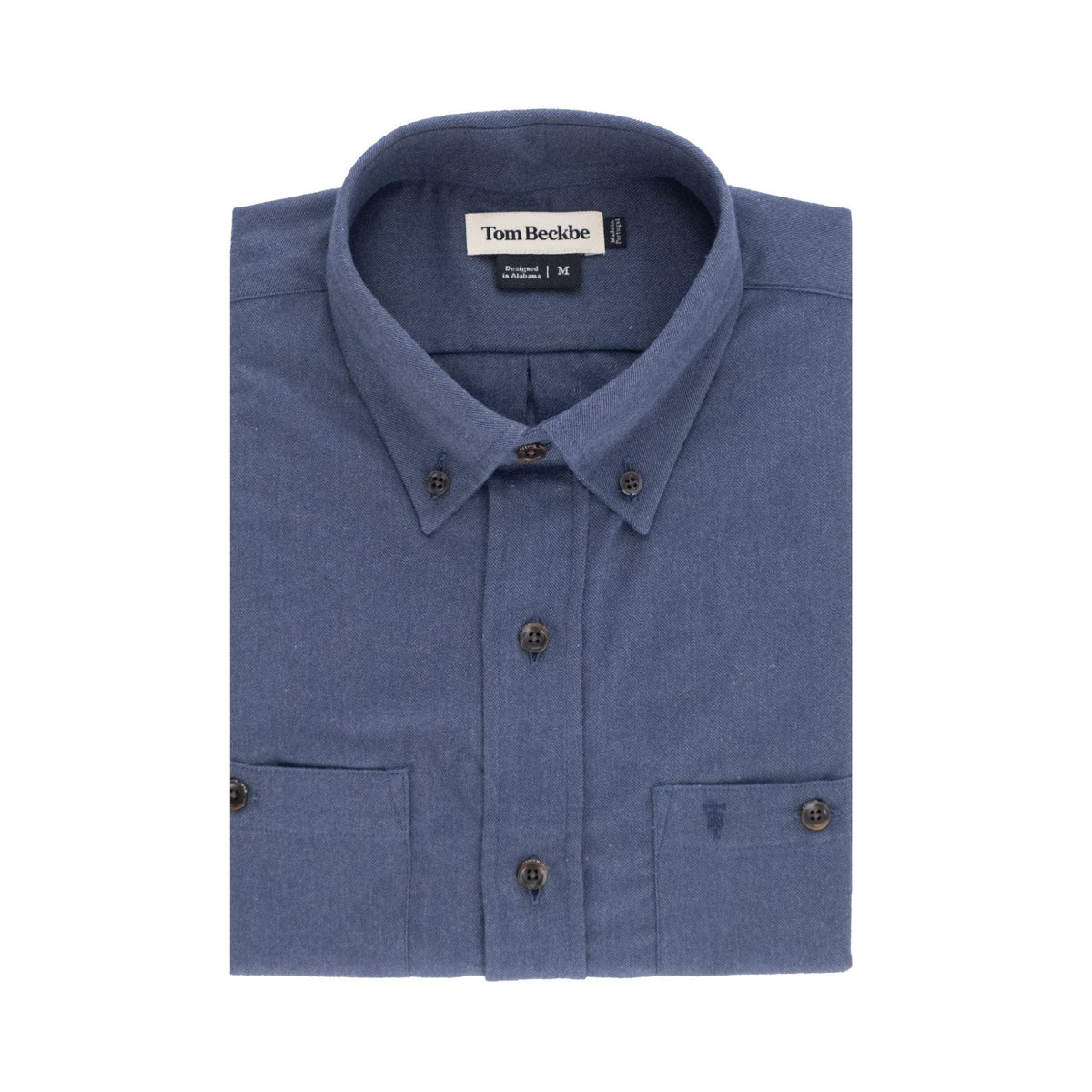 A folded blue Dixon Brushed Cotton Twill Shirt by Tom Beckbe with a collar and inner Tom Beckbe label.