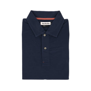 Coastal Polo Shirt by Tom Beckbe: Navy blue, folded, with collar and two buttons, label inside the collar.