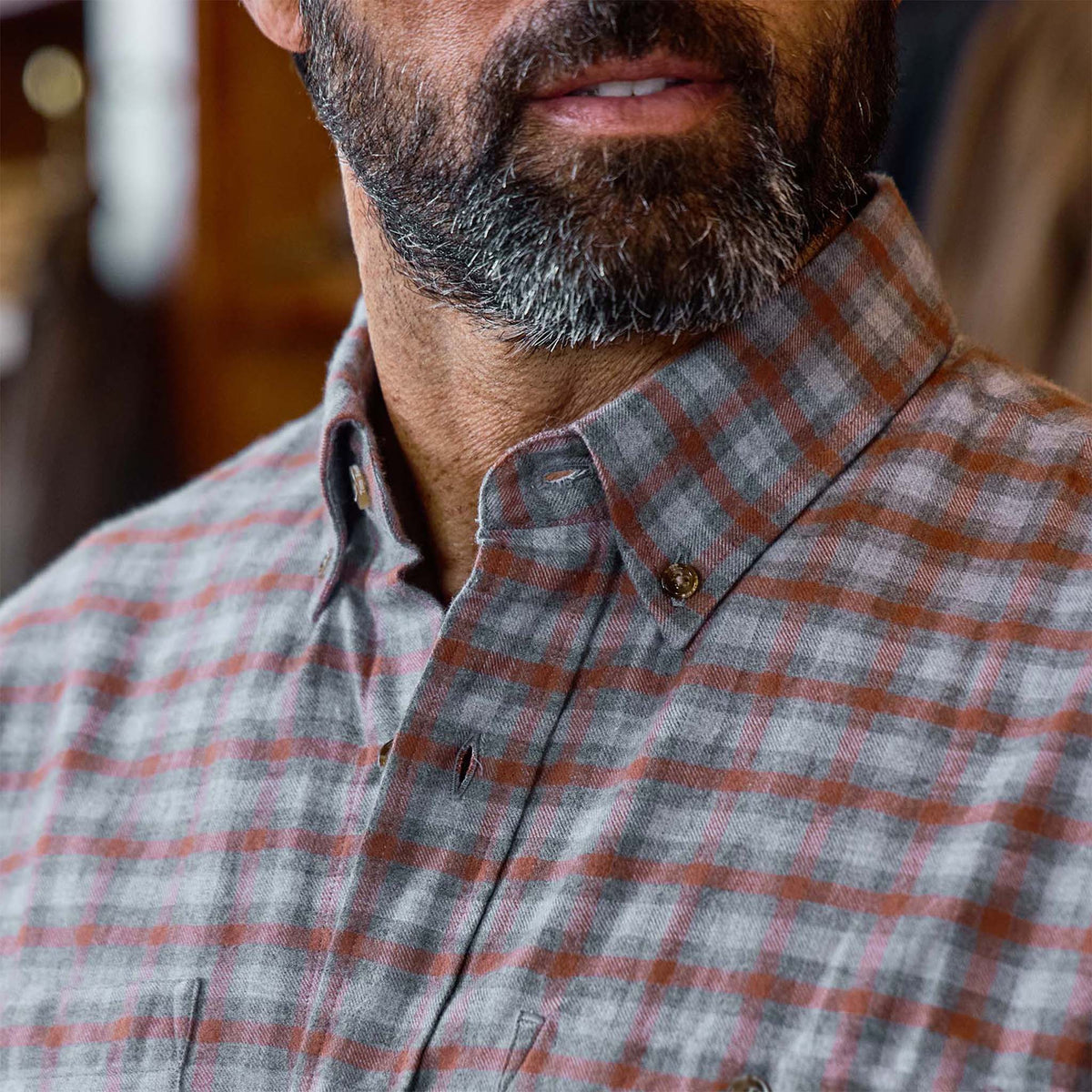 Close-up of a bearded man in the Tom Beckbe Dixon Brushed Cotton Twill Shirt, gray and red plaid.
