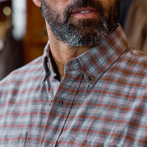 Close-up of a bearded man in the Tom Beckbe Dixon Brushed Cotton Twill Shirt, gray and red plaid.