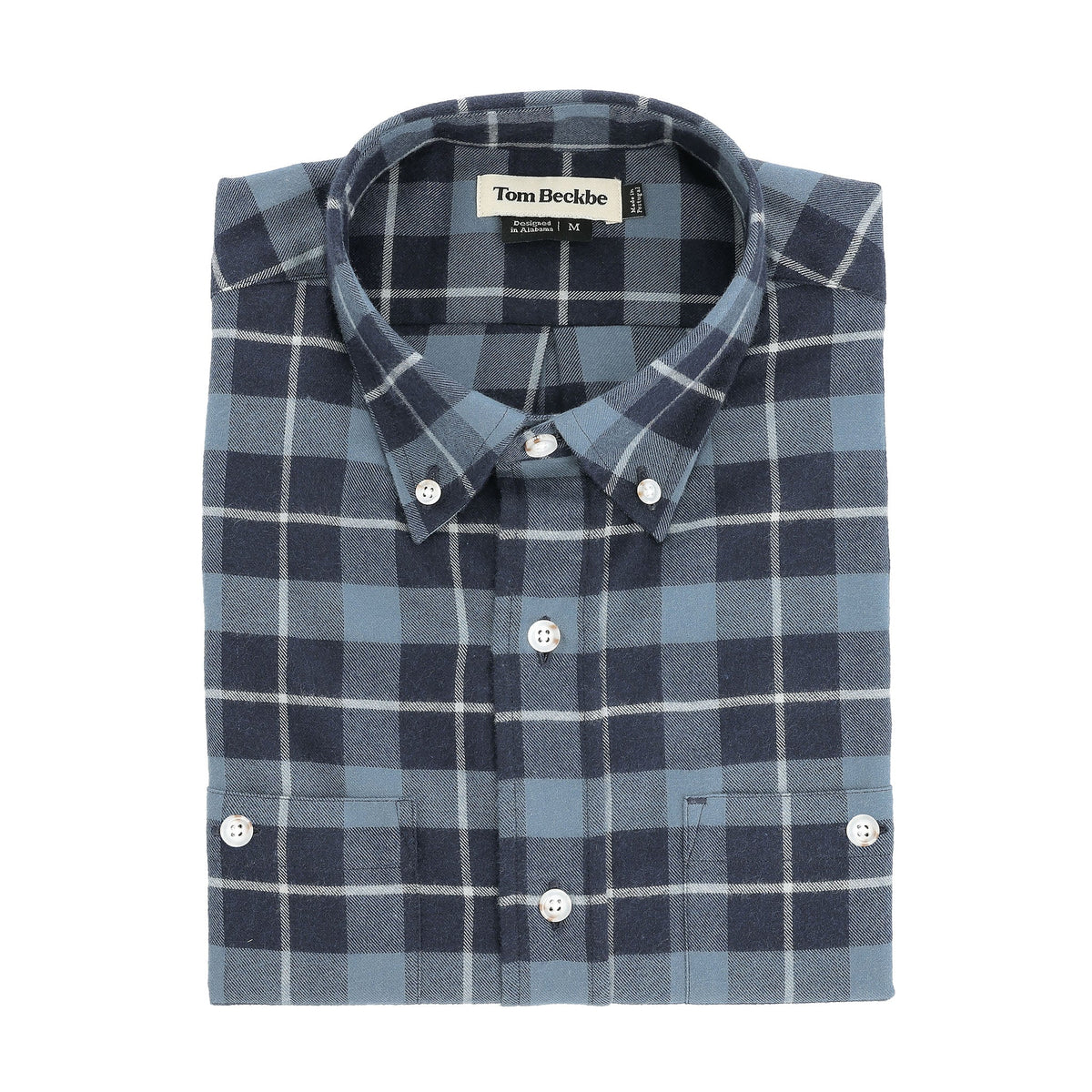 The Dixon Brushed Cotton Twill Shirt by Tom Beckbe features blue and gray plaid, white buttons, and a visible brand label.