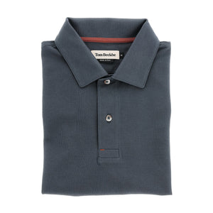A folded dark gray Hutton Performance Polo for men with a collar and three buttons, by Tom Beckbe.