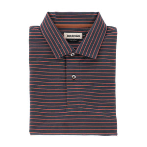 A folded Tom Beckbe Hutton Performance Polo for men in navy with thin red stripes and a two-button collar.