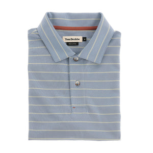 A folded light blue Hutton Performance Polo by Tom Beckbe with thin white stripes and a branded collar label.