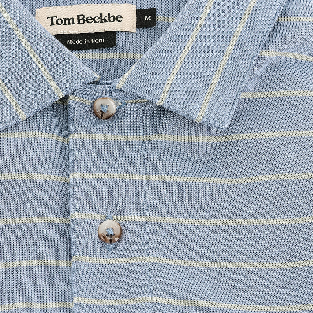 Close-up of Tom Beckbe's Hutton Performance Polo for men in blue with yellow stripes and button placket.