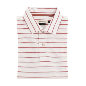 The Tom Beckbe Hutton Performance Polo is a white, moisture-wicking polo with red stripes and a buttoned collar.