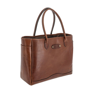 Tom Beckbes Palmer Leather Tote: A compact brown bag with dual handles, side pockets, and embossed logo in full-grain leather.