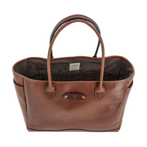 The Palmer Leather Tote by Tom Beckbe features two handles, a spacious interior, and a front metal logo plate.