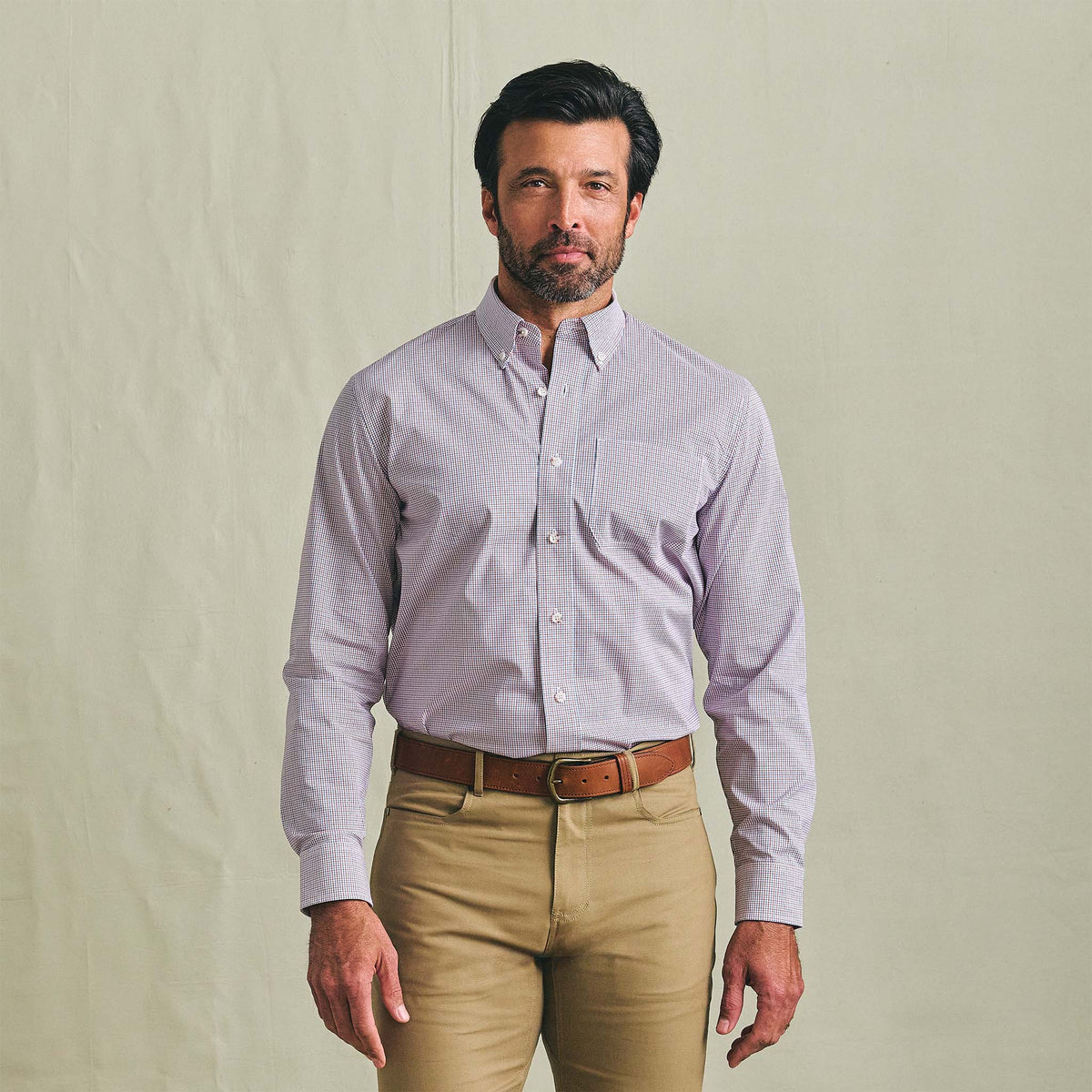 Man facing forward in a Tom Beckbe Powell Performance Shirt with UPF 30+, paired with khaki pants, on a light background.